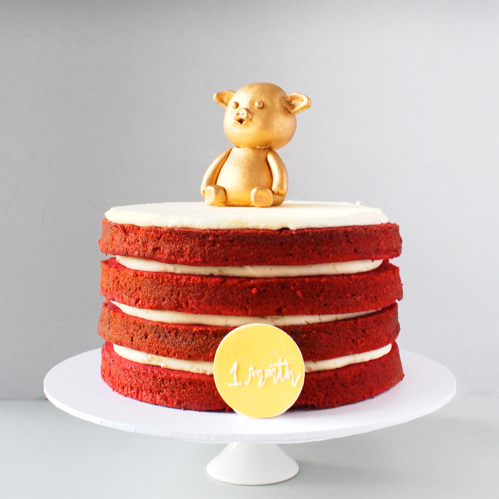 Naked Red Velvet Birthday Cake with a Golden Pig Topper