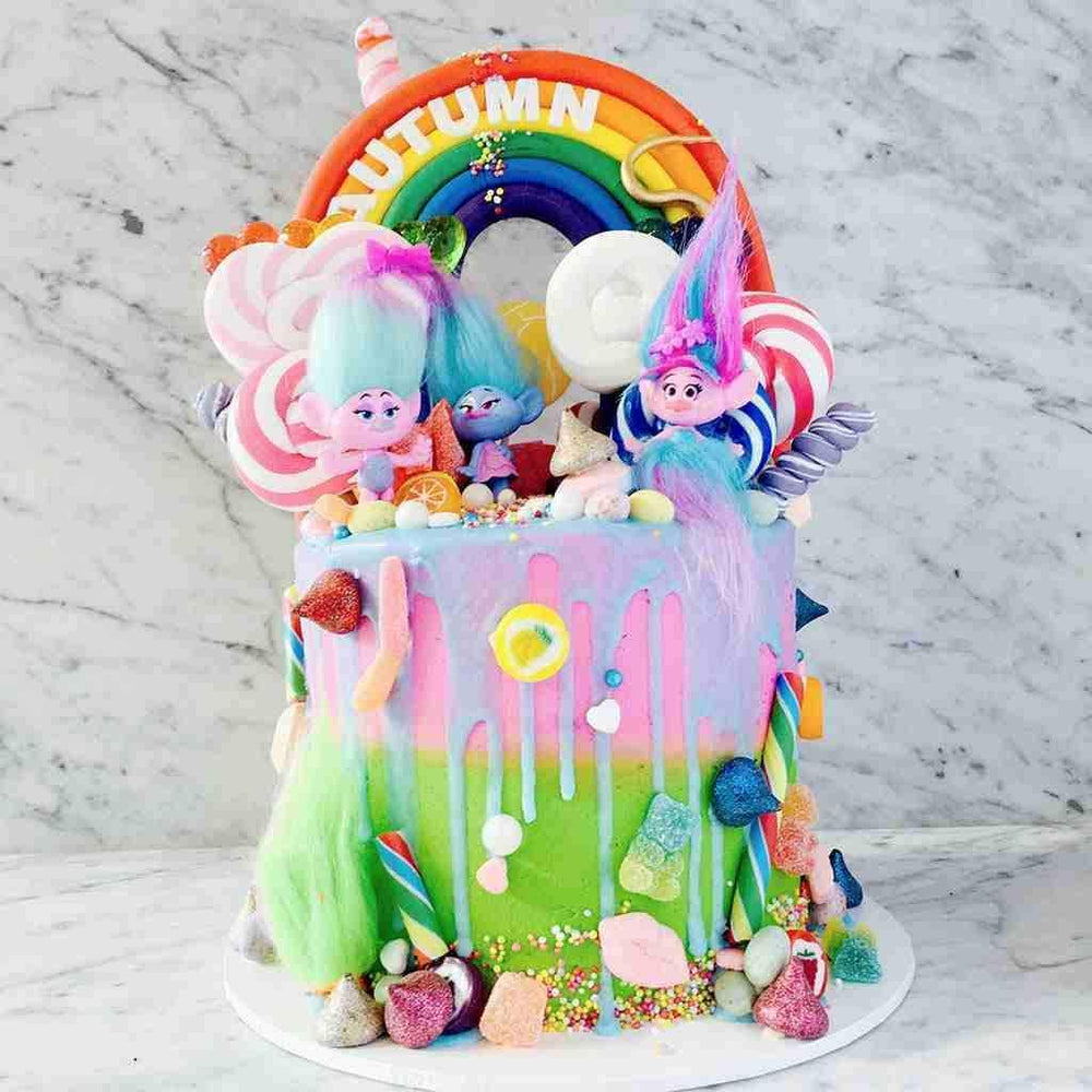 Troll Dolls on Rainbow Drip Cake